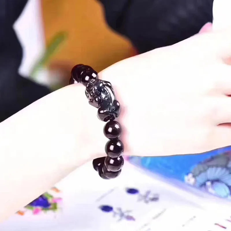 Natural ice colour eye obsidian crystal bracelet on wrist showing bead detail.