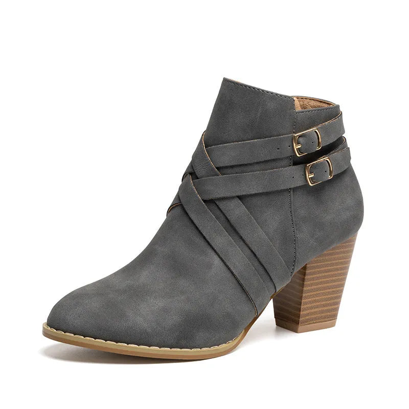 Women's grey short ankle boots with a block heel, side zipper, and buckle strap on a white background.