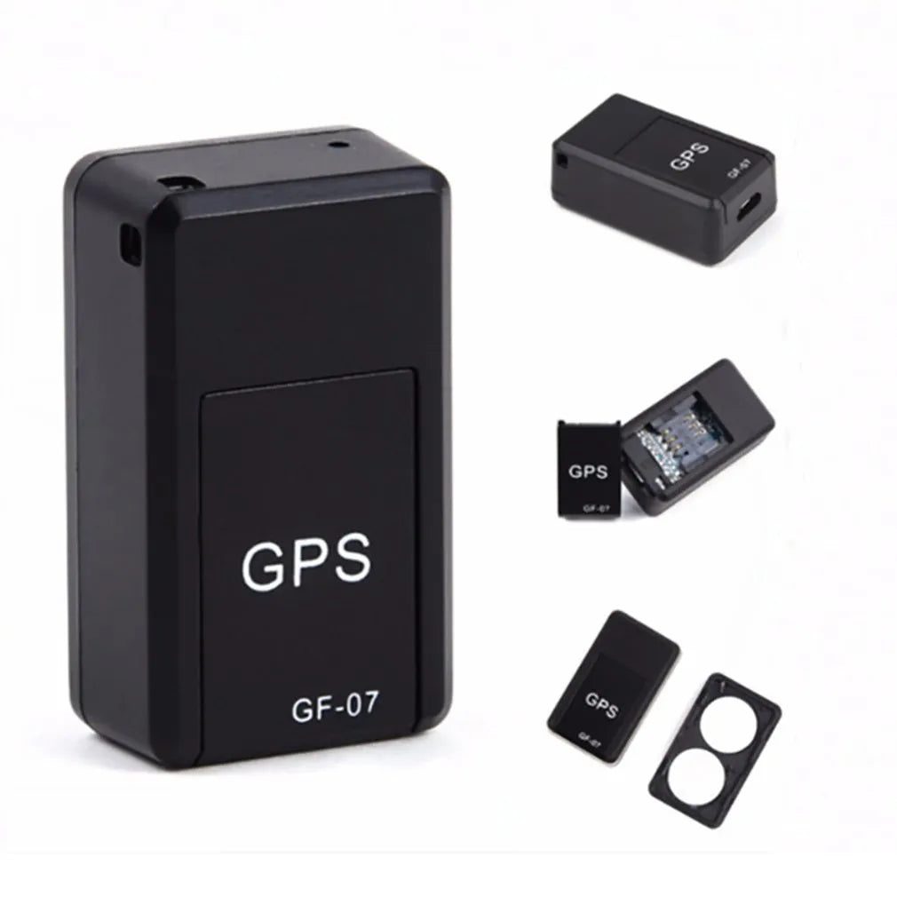 Small black plastic magnetic GPS car tracker device with USB cable.
