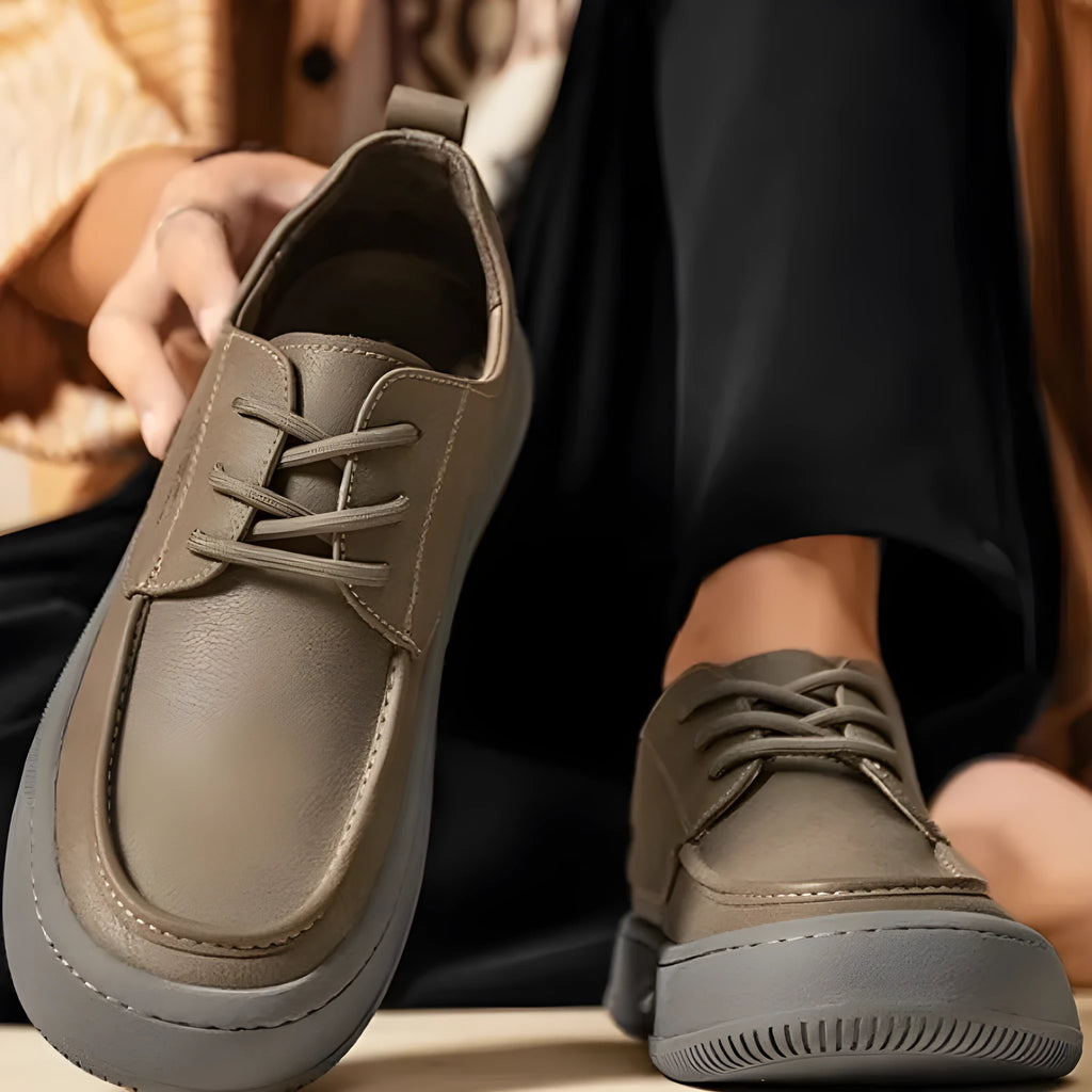 Brown retro-style casual leather shoes with big toe design on a neutral background
