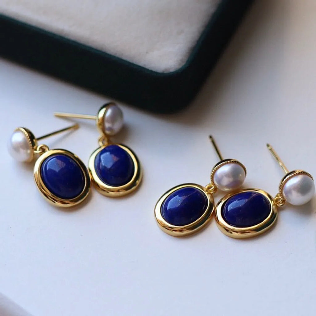 A pair of simple 925 silver drop earrings with a blue lapis lazuli pearl and auspicious patterns.