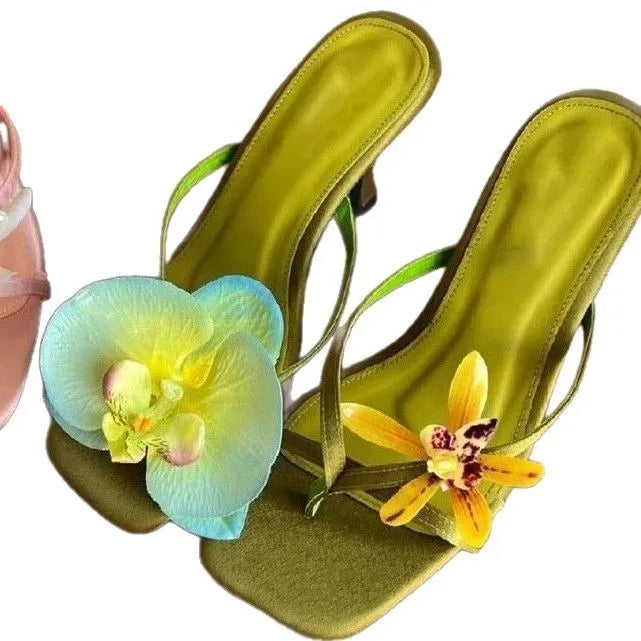 Women's handmade asymmetric floral high heel sandal in calf leather on a white background.
