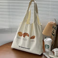 Beige canvas shoulder bag with bread design showing 44cm width and adjustable shoulder strap