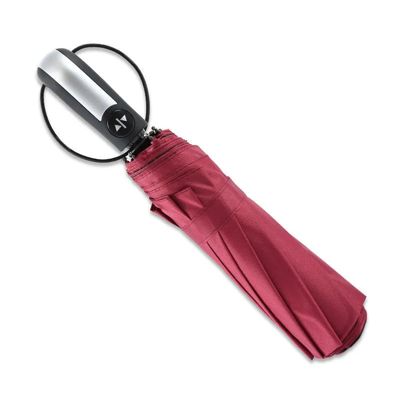 Black triple-folding automatic umbrella open, showing classic palace-style canopy shape.