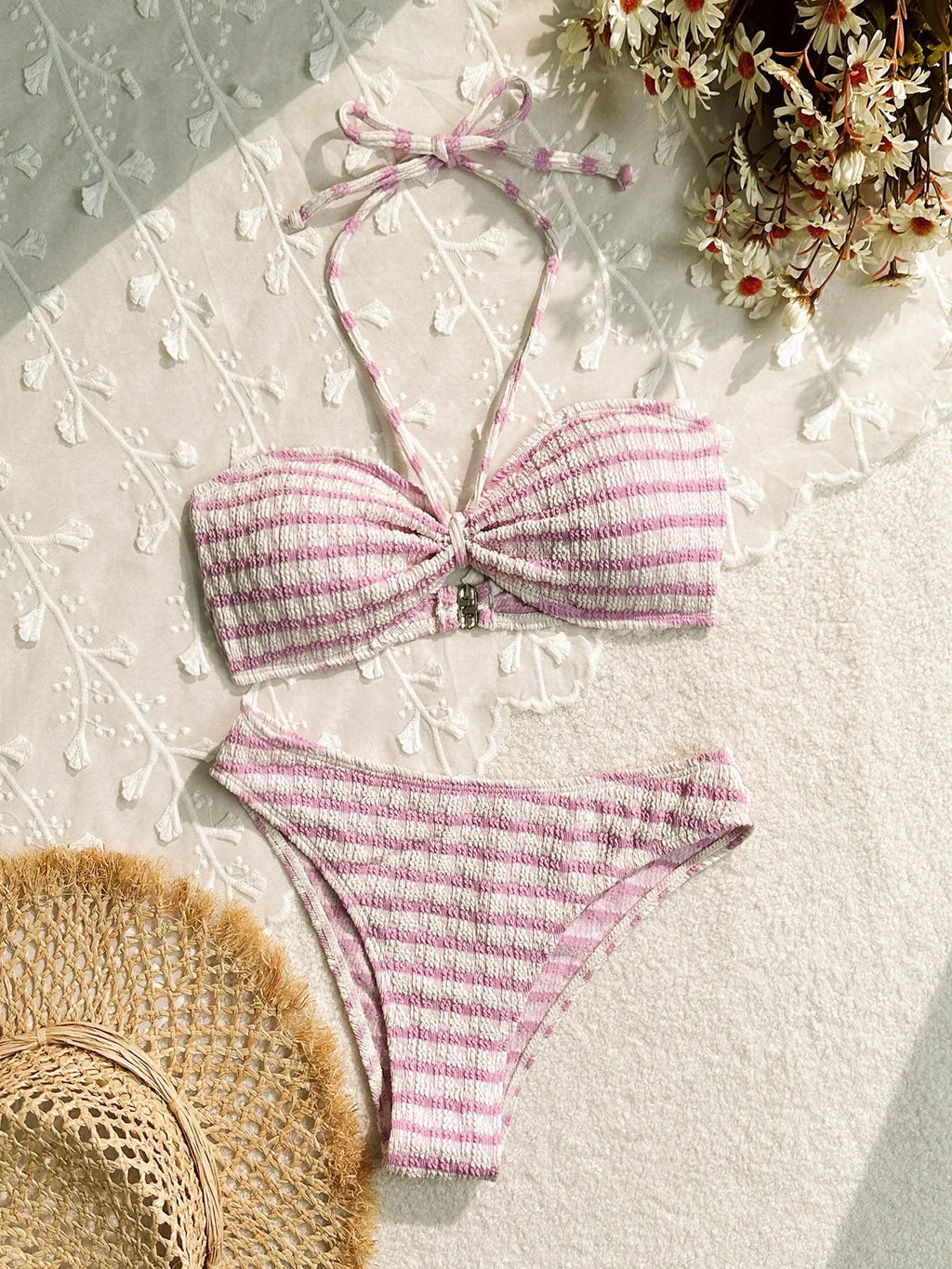 Women's pink and black striped bikini swimsuit with briefs style on a mannequin.