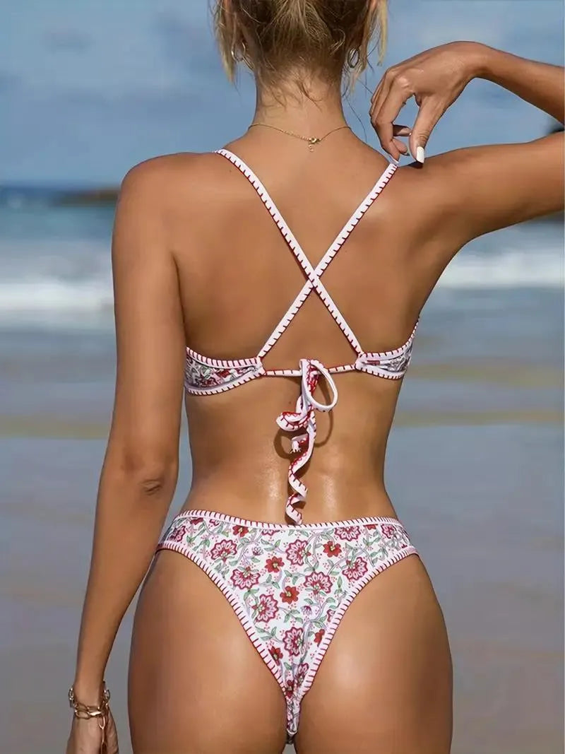 Women's V-neck swimsuit with floral embroidery in polyester fabric showing brief style cut