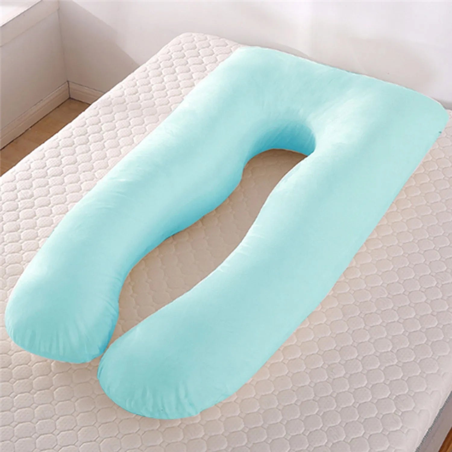 U-shaped pregnancy pillow in light blue ice silk fabric on a bed.