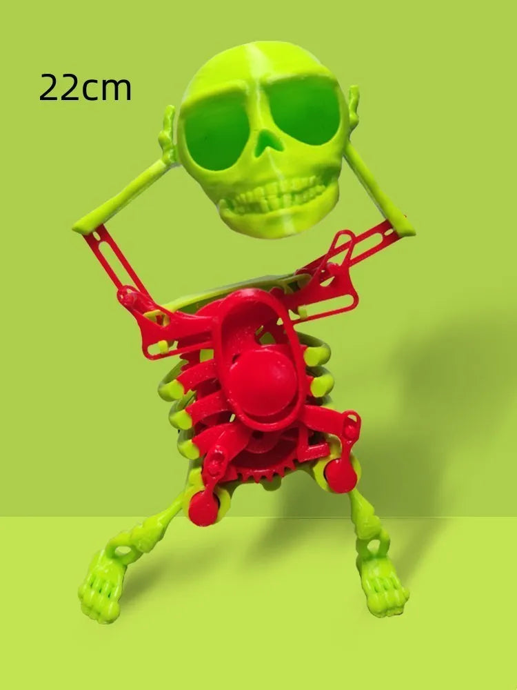 3D printed dancing skeleton gravity toy in pink and white, 22cm tall, on a desk