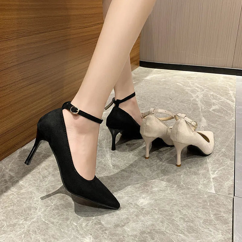 Women's black stiletto heel pump shoes with buckle detail on side