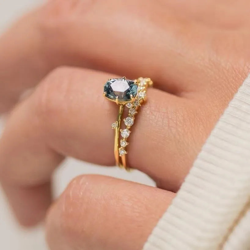 Gold plated floral fashion ring with green zircon stone inlay on finger