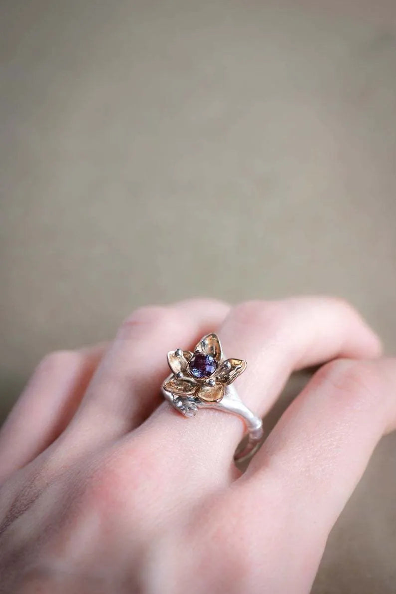 Silver two-tone floral geometric women's alloy ring on a plain background.
