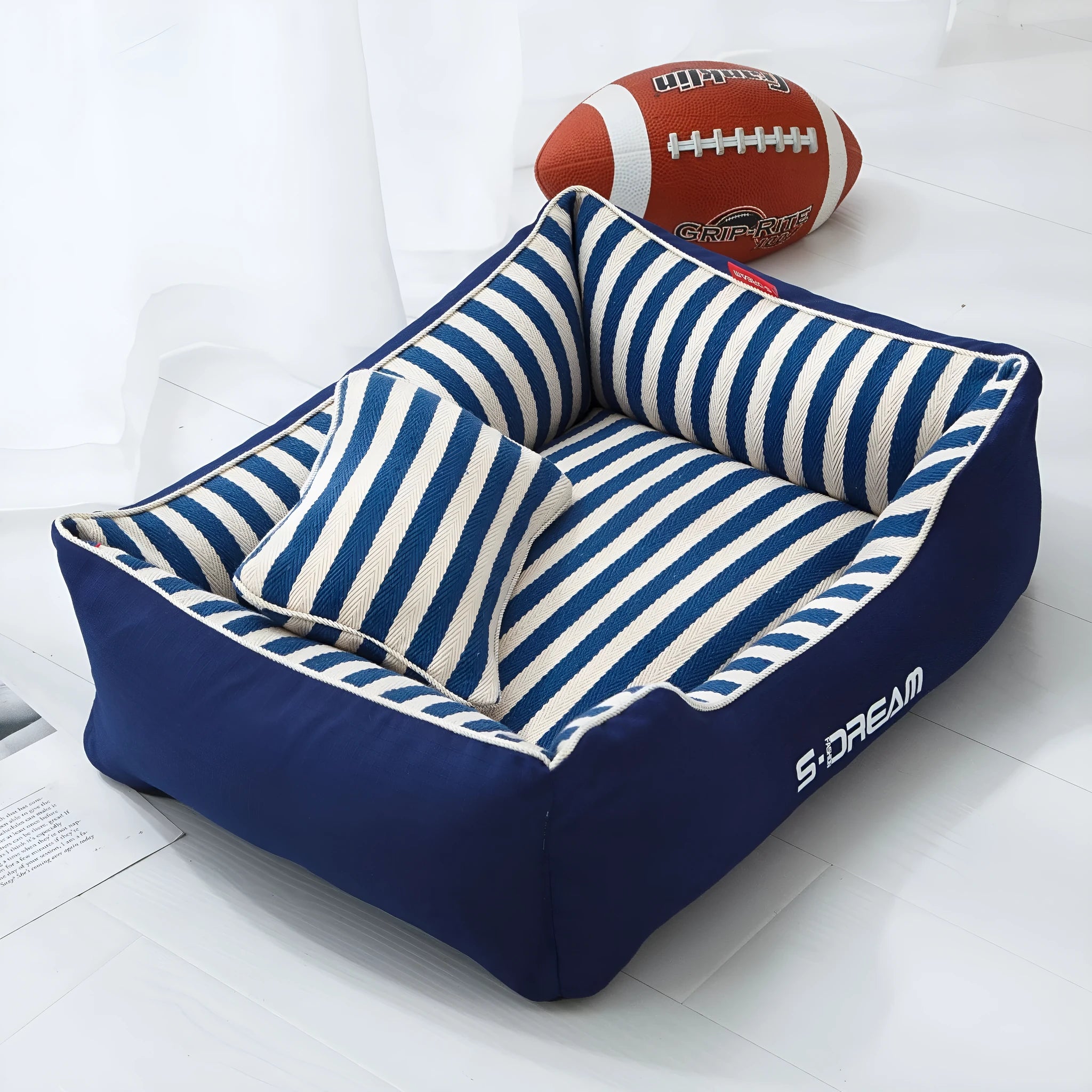 Navy stripes dog crate mat and matching fabric pillow set on a white background.