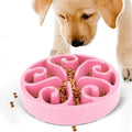 A coloured slow feeder dog bowl with a maze pattern inside and a wide non-slip base.