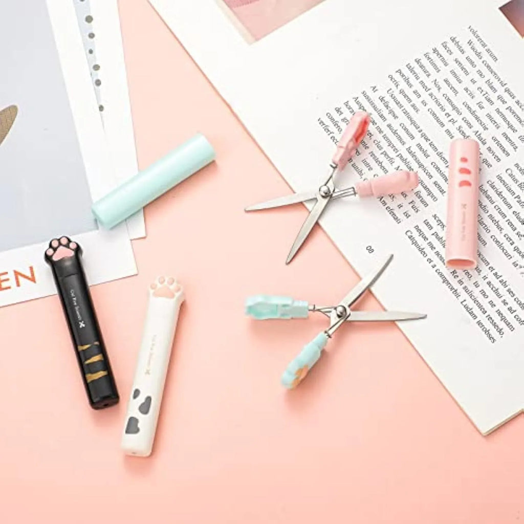 Cat paw design mini folding scissors in pink, showing stainless steel blades and compact size.