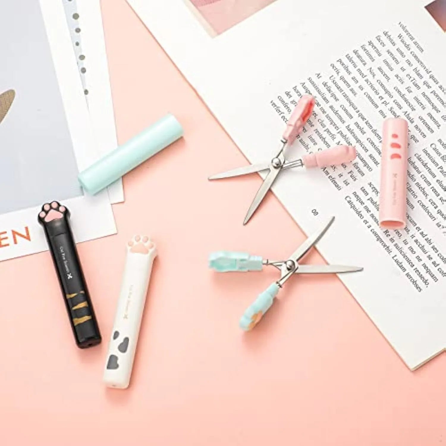 Cat paw design mini folding scissors in pink, showing stainless steel blades and compact size.