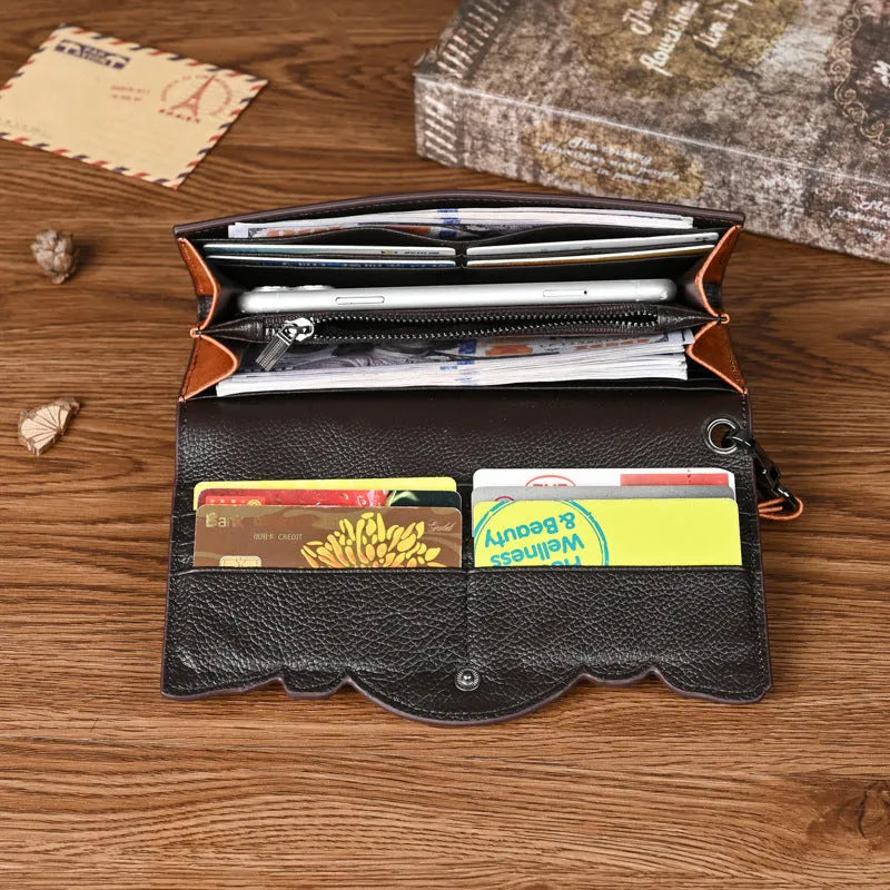 Women's brown cowhide tri-fold wallet with embossed floral pattern showing open compartments
