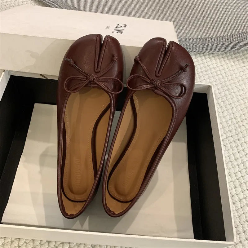 Women's split-toe flat pump shoes in beige with a round toe and shallow cut.