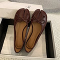 Women's split-toe flat pump shoes in beige with a round toe and shallow cut.