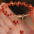 Red ginkgo leaf charm on a silver-toned magnetic alloy bracelet in Chinese natural style.