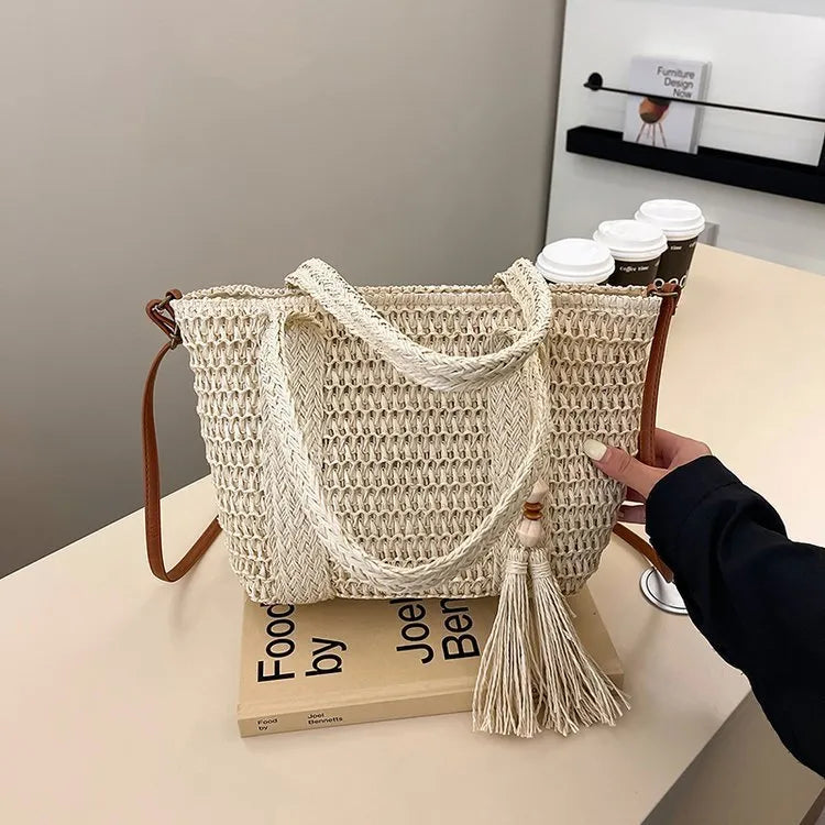 Large straw crossbody bag with woven raffia construction and polyester lining