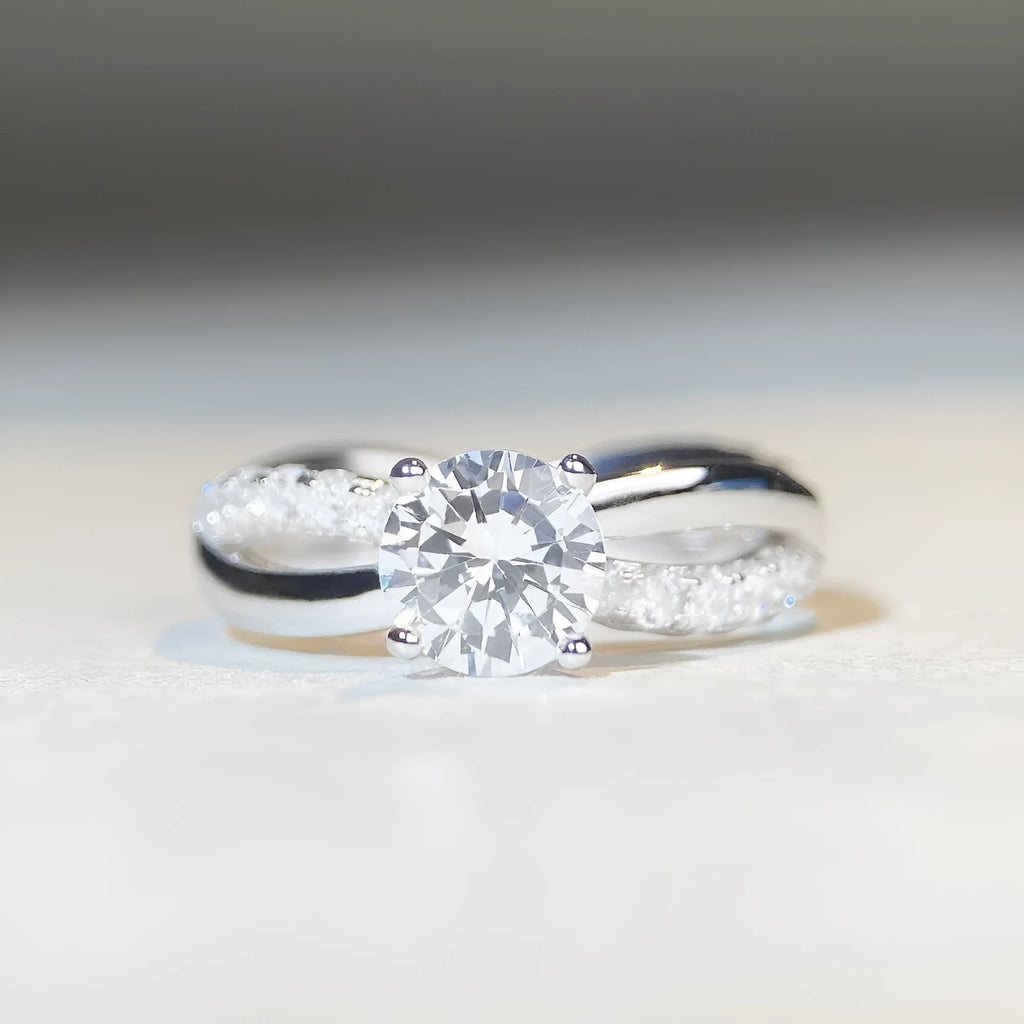 Geometric twist arm silver ring with 1 karat moissanite stone in four-claw winding setting