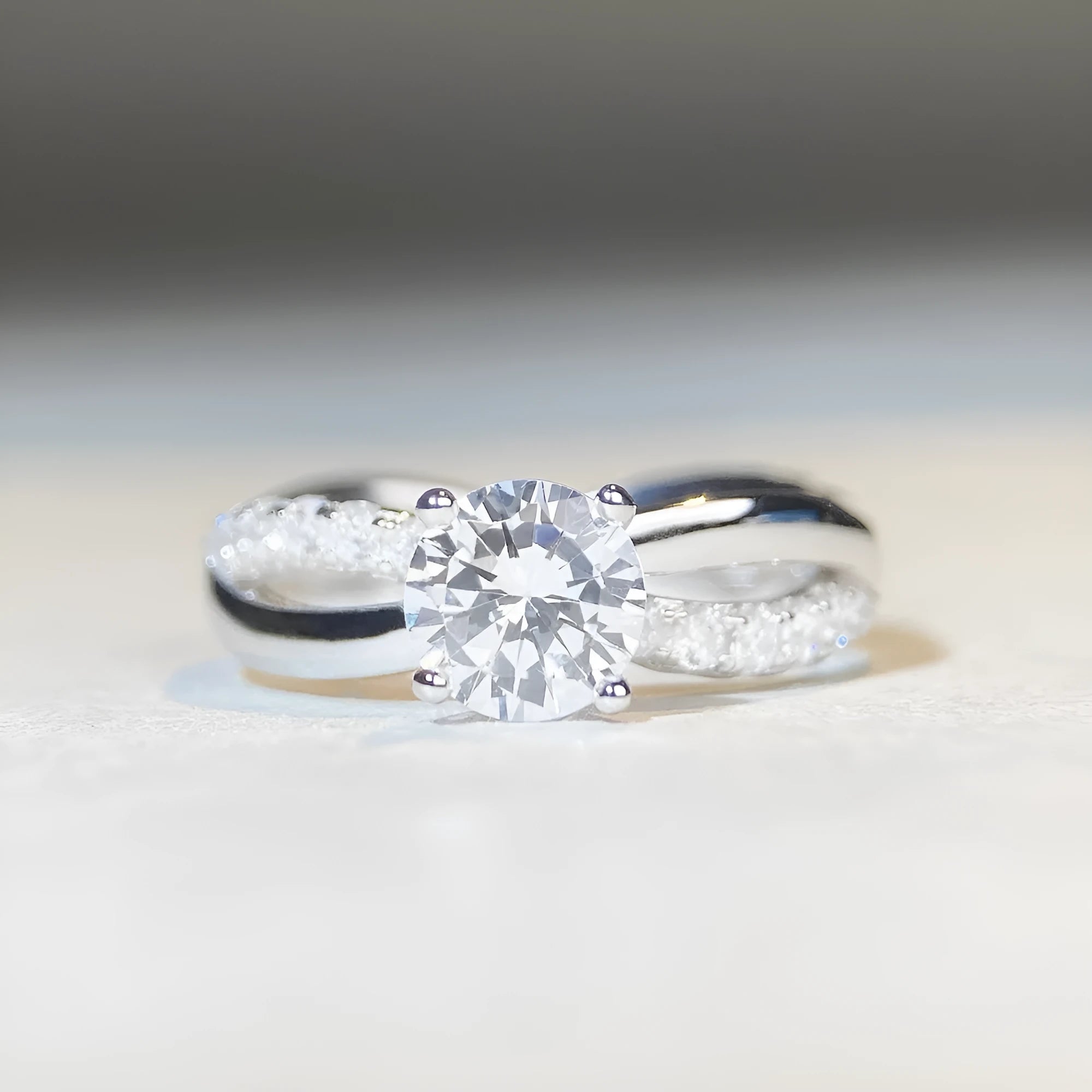 Geometric twist arm silver ring with 1 karat moissanite stone in four-claw winding setting