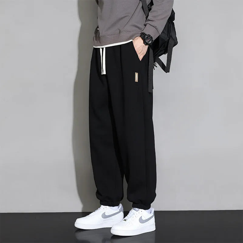 Men's loose fit grey cotton sports trousers with elastic waistband and drawstring closure