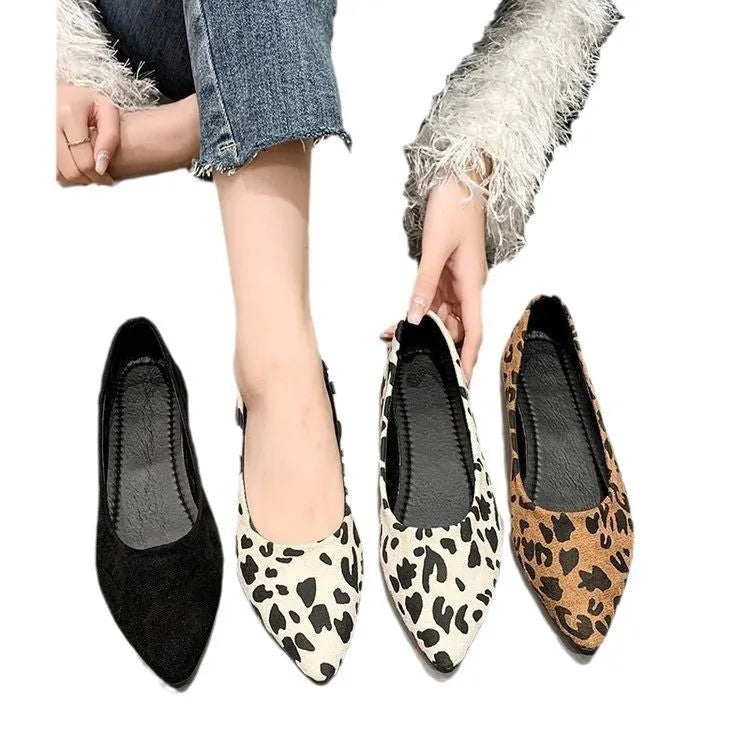 Women's leopard print pointed toe flat pumps with low heel on a white background.