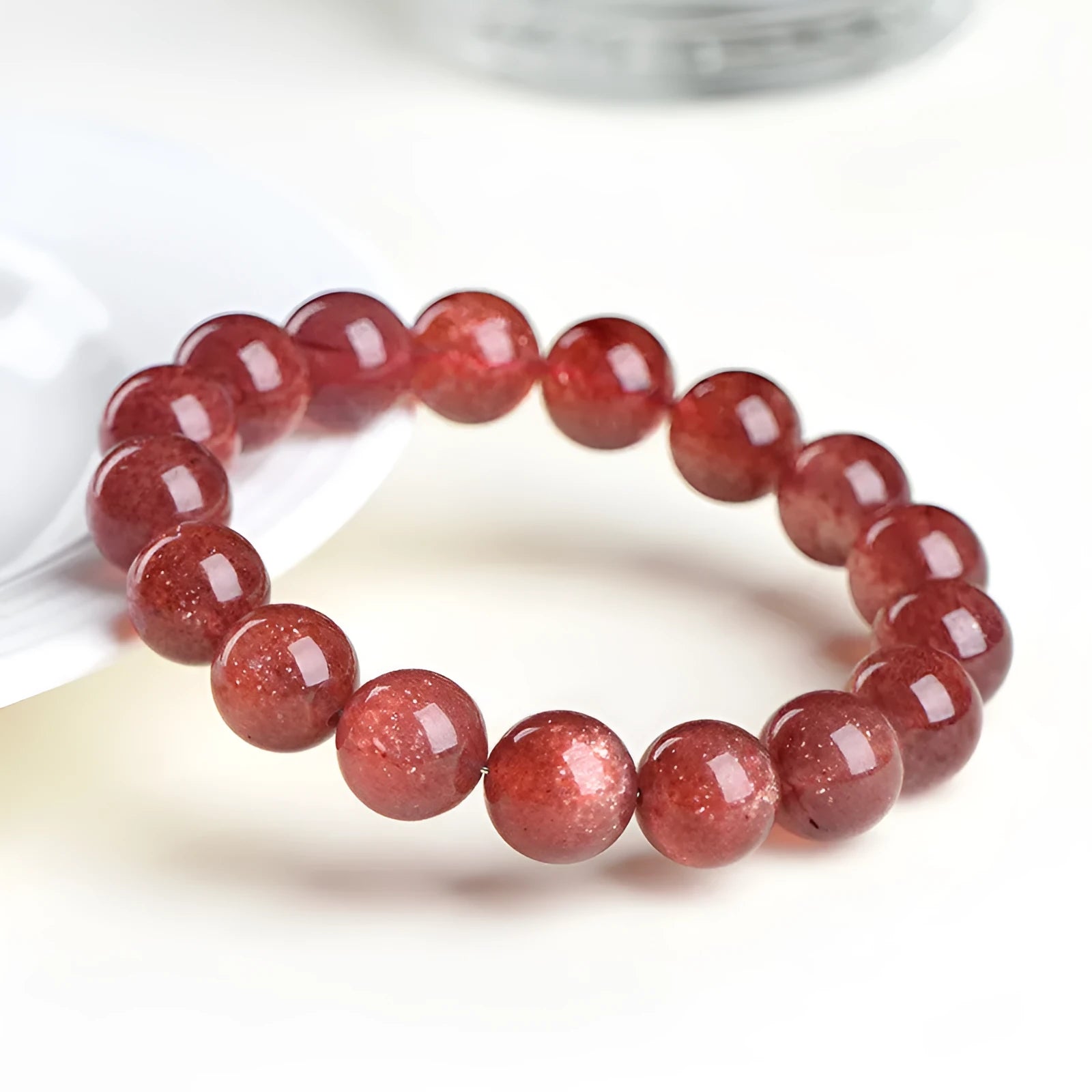 Natural strawberry quartz crystal bracelet with polished red geometry beads, shown in 3A and 5A grade options.