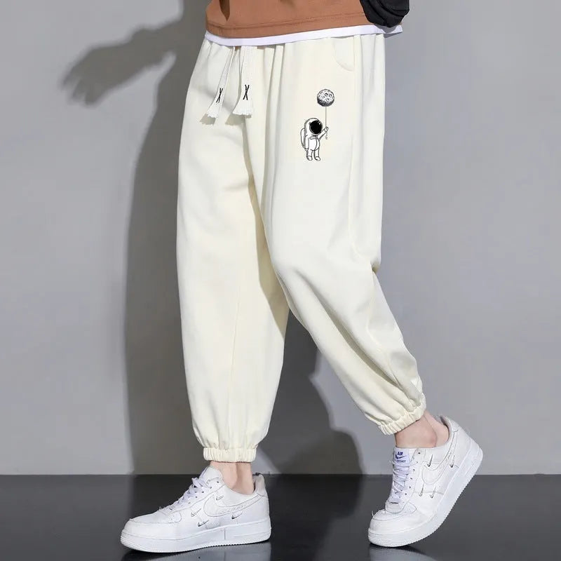 Men's cropped casual loose tapered pants in black, 100% polyester, mid waist, cropped length, sizes M to 4XL.