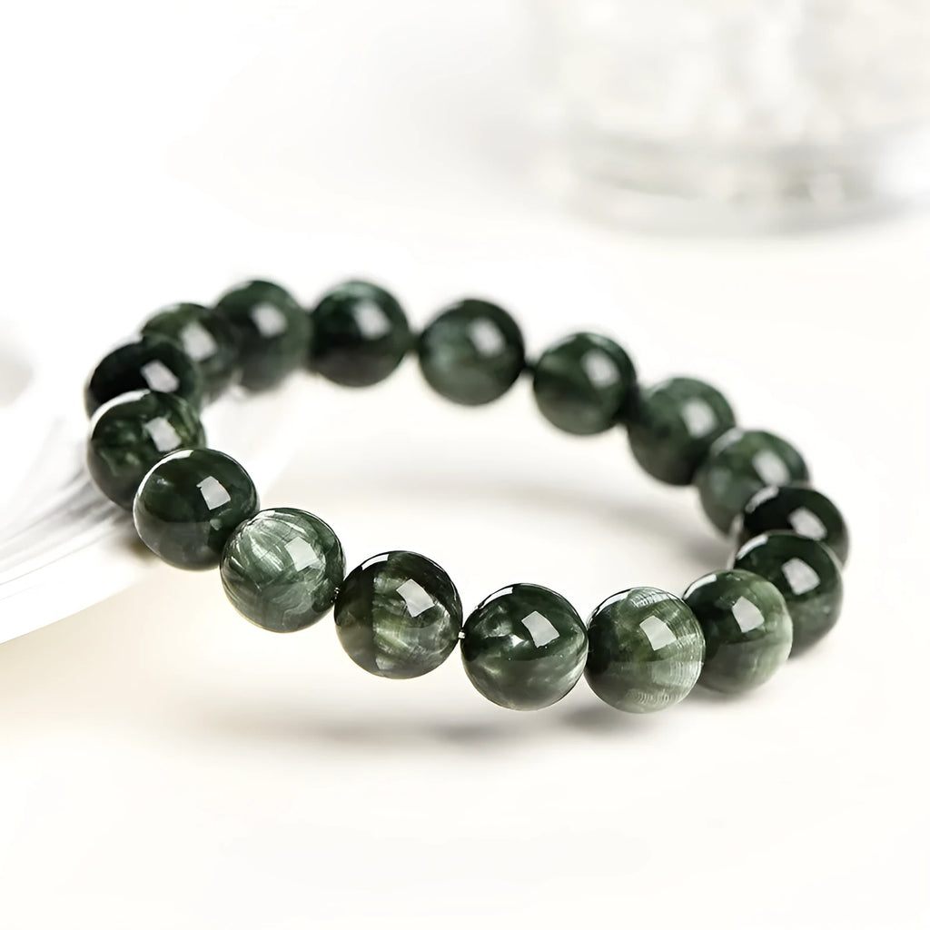 Green Dragon Crystal bracelet with round beads featuring Ruyi design elements.