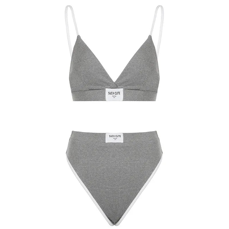 Women's grey bikini set with contrast binding embroidery detail showing sleeveless top and shorts