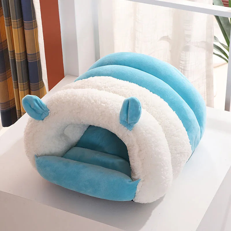 Blue enclosed cat nest with fluffy fleece interior, shown with a removable washable cover.