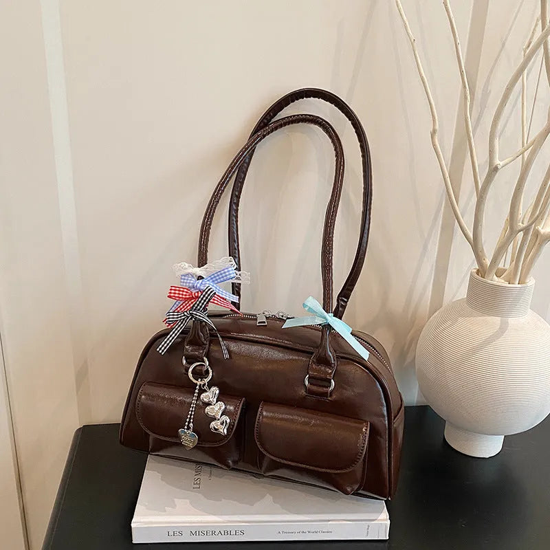 Women's brown PU leather retro pillow handbag with flap and ribbon pendant carried on shoulder
