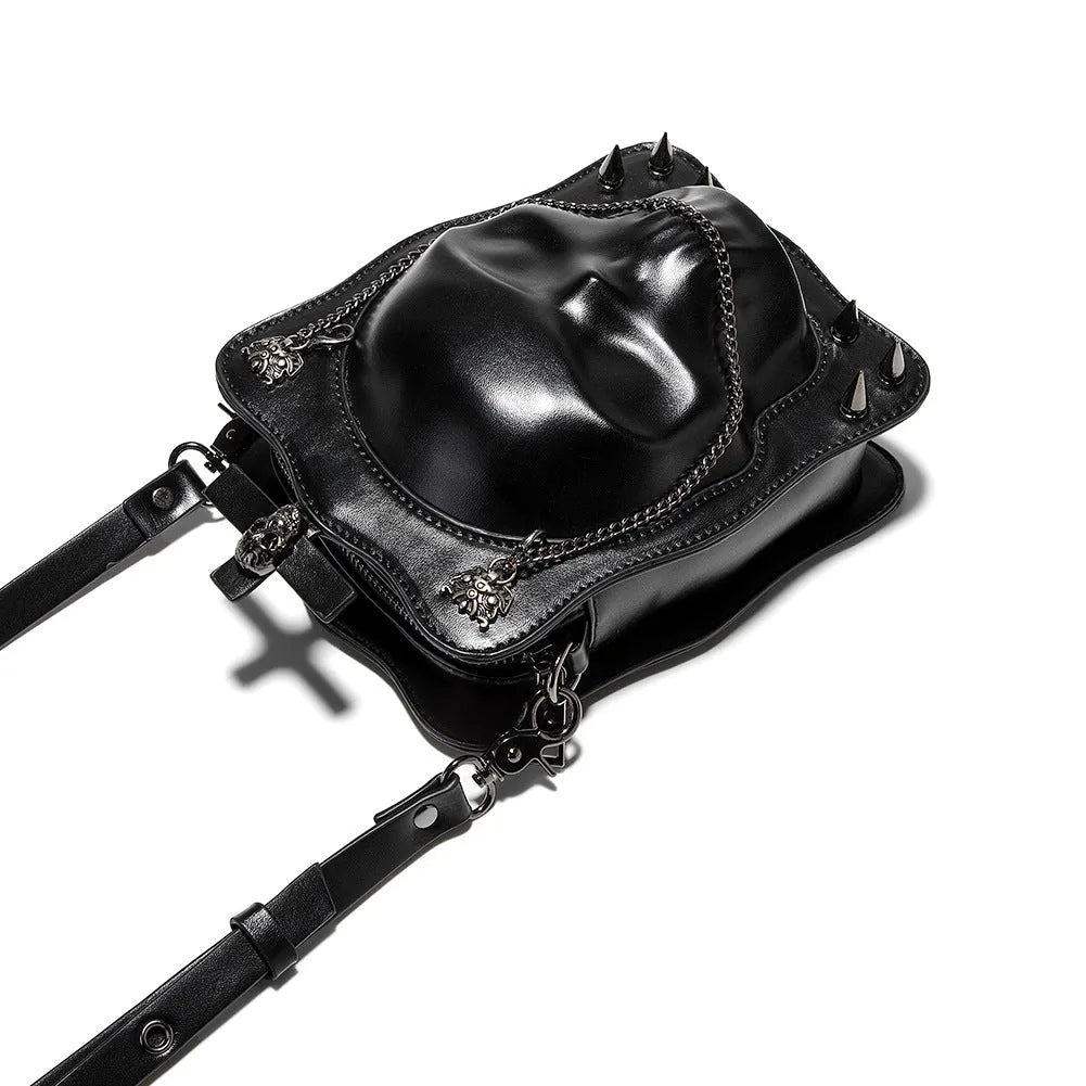Black mini square messenger bag with a gothic embossed skull design, chain detail, and a crossbody strap.