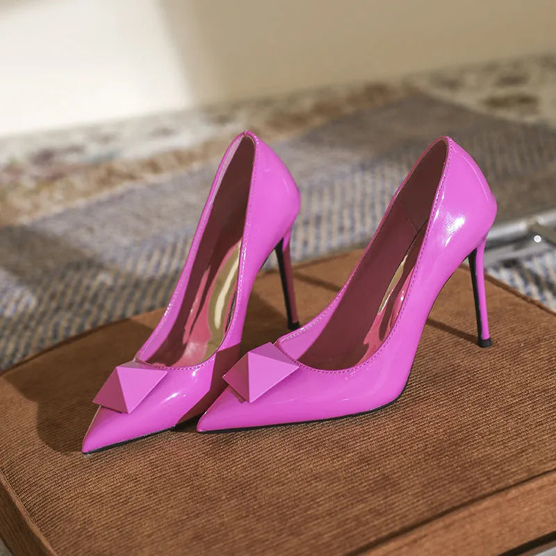 Women's pink patent leather pointed toe stiletto high heels with buckle detail