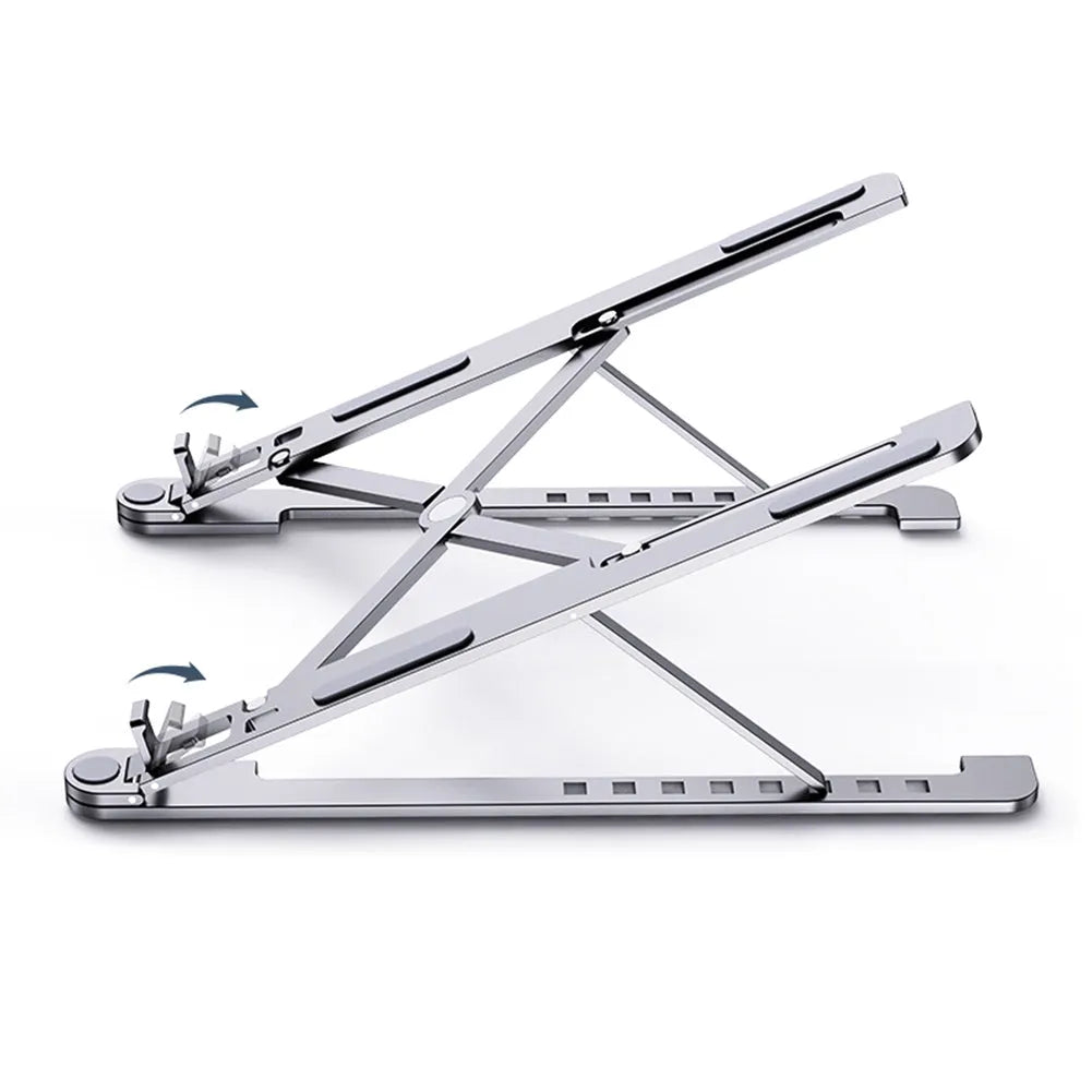 A folded aluminium laptop stand in rose gold next to an open silver laptop on a desk.