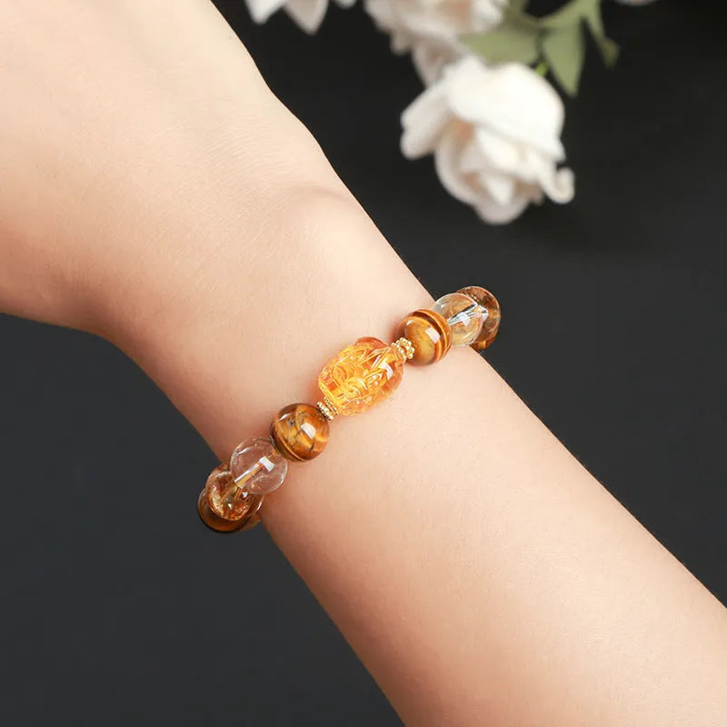 Yellow tiger's eye and citrine gemstone bracelet with 10mm round beads and a silver steel Pi Xiu charm.