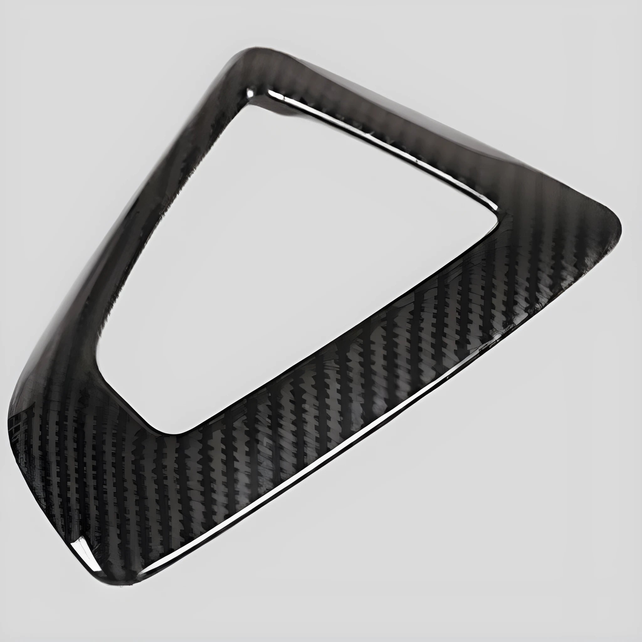 BMW gear base frame in left titanium colour with carbon fibre pattern, showing 3M adhesive backing.