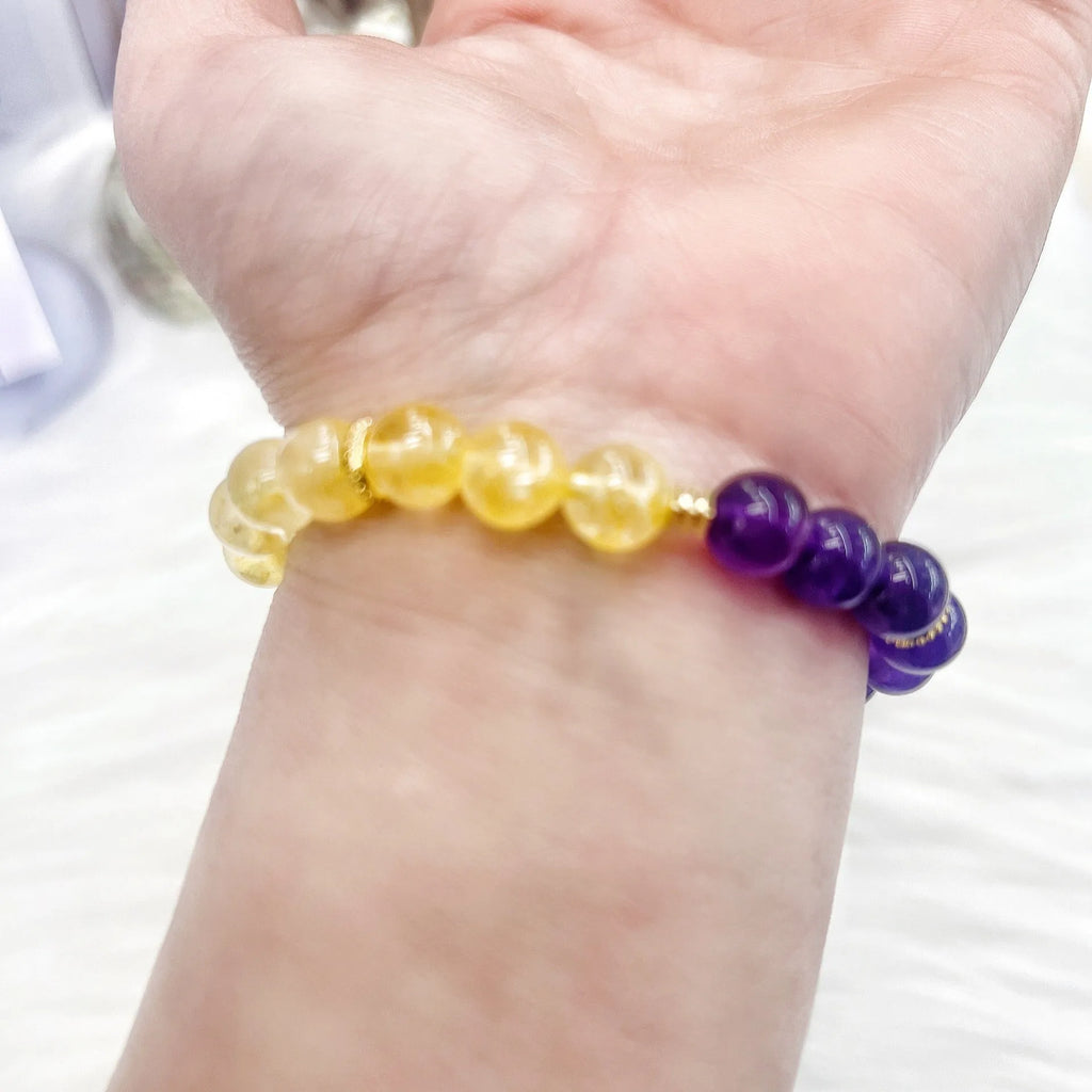 Handmade women's yellow and purple bracelet with amethyst and crystal beads featuring adjustable sliding knot closure