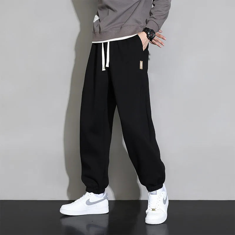 Men's loose fit grey cotton sports trousers with elastic waistband and drawstring closure