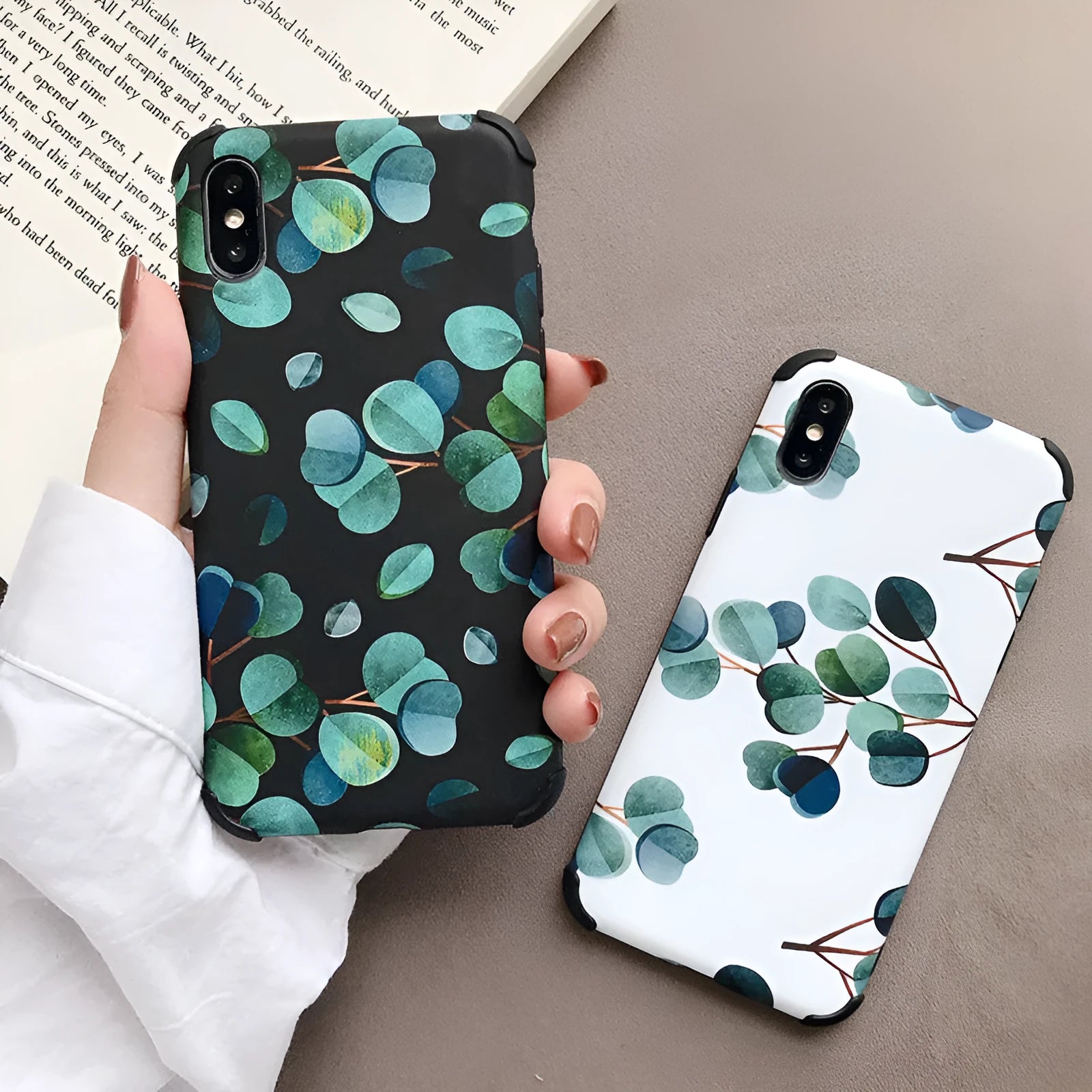 Black silicone iPhone case with a detailed leaf pattern design on the back.