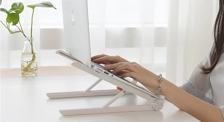 White Whale Race laptop bracket with desktop elevation and integrated heat sink base on desk