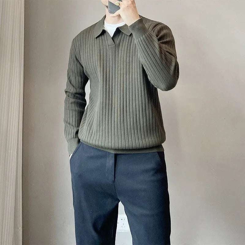 Man wearing a loose grey striped knit sweater with a lapel, long sleeves, and textured fabric.