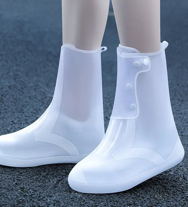 White PVC high-top reusable waterproof shoe cover for women, shown on a foot.
