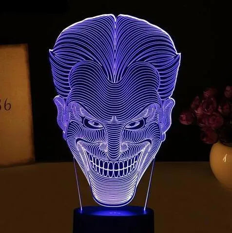 USB-powered 3D acrylic LED lamp displaying multiple colours, shown with its remote control and stand.