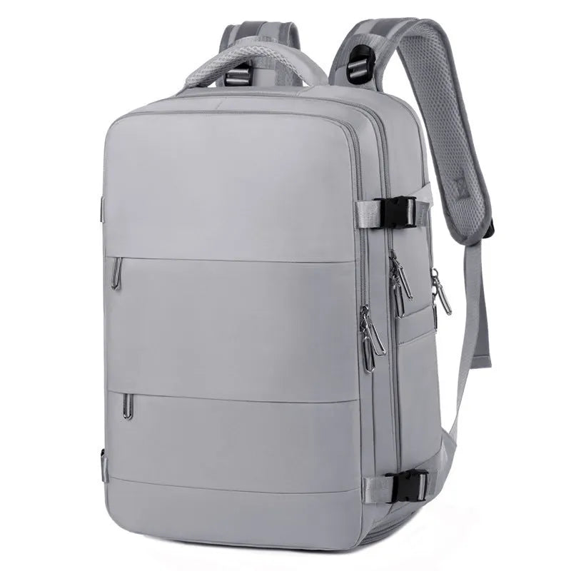 Large purple women's travel backpack with multiple pockets and air pillow belt on a grey background
