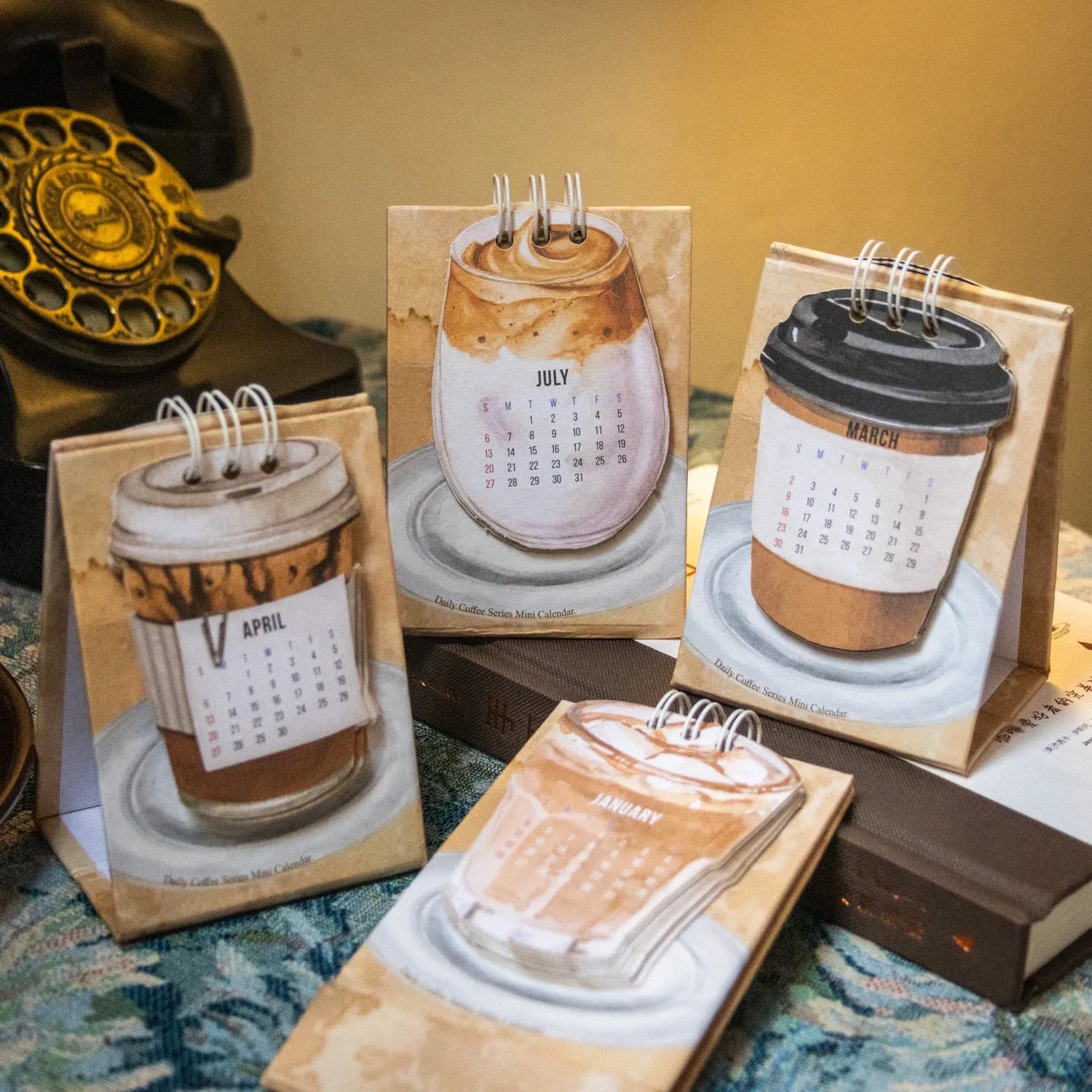 Coffee Coffee mini desk calendar set showing four 2025 paper calendars with different themes for daily inspiration