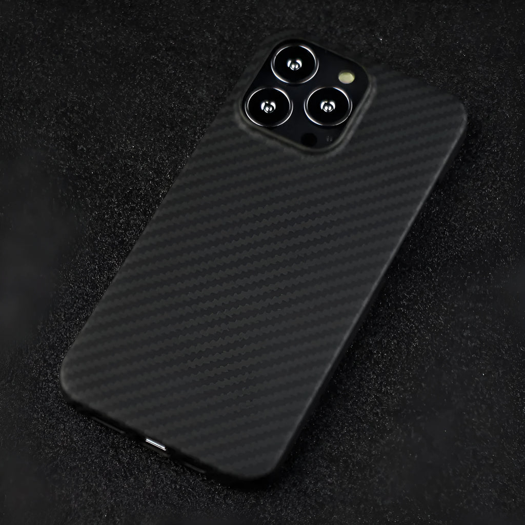 Matte black real carbon Kevlar fibre protective case for Apple iPhone, showing crater texture detail.