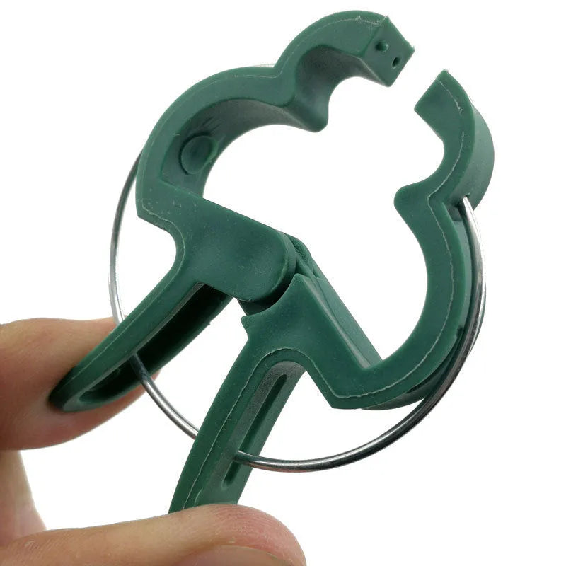 Green plastic and zinc plant fixing clips in large and small sizes for garden vine support.